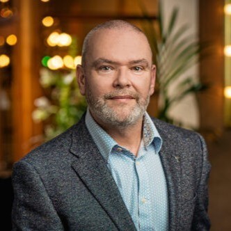 Photo of Keith Doran, a satisfied client of Ideaz to Appz, sharing his positive experience with expert product management services